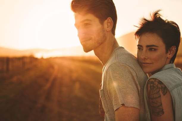 istock Woman embracing a man outdoors on a road trip 979028212