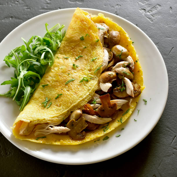istock Omelette with mushrooms, chicken meat, greens 979031906