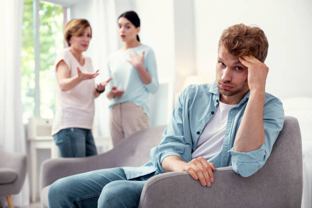 istock Sad young man sitting in the armchair 979031962