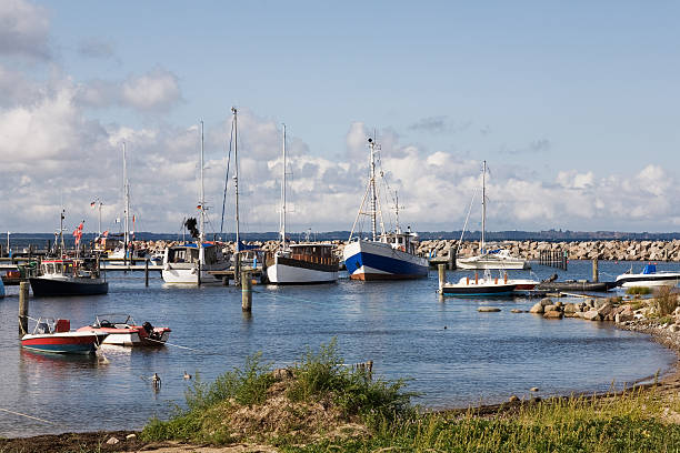Small fishing boats moored in marina in Southern Danish sunshine