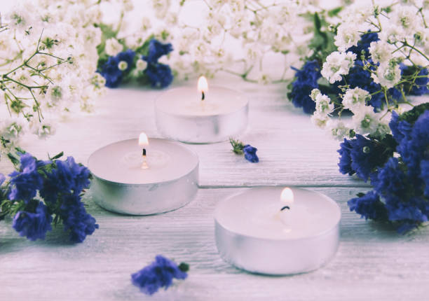 istock Candles, white and blue flowers on a white background 979039516