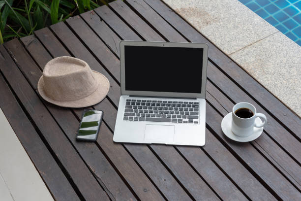 istock laptop and hat at the pool. 979042832