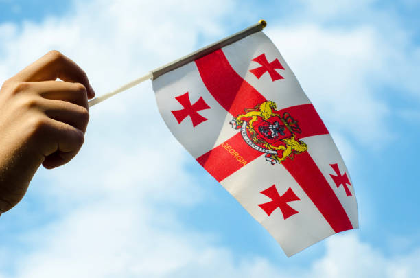 istock Hand with the flag of Georgia. 979043922