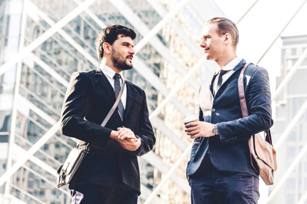 istock Image two business partners talking and working together while discussing new strategy at city 979047140
