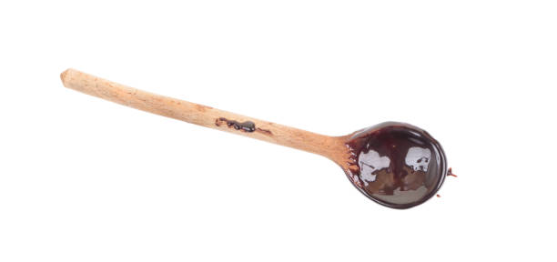 istock Chocolate on wooden spoon isolated on white background. Top view. 979053002