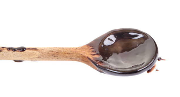 istock Chocolate on wooden spoon isolated on white background. 979053128