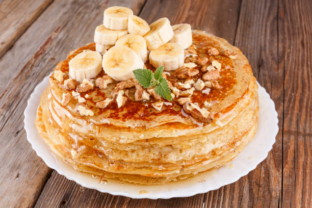 istock Stack, pancake, pancakes, honey, banana, nuts, Healthy breakfast 979054616