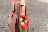 Girl holding red elegant shoes
