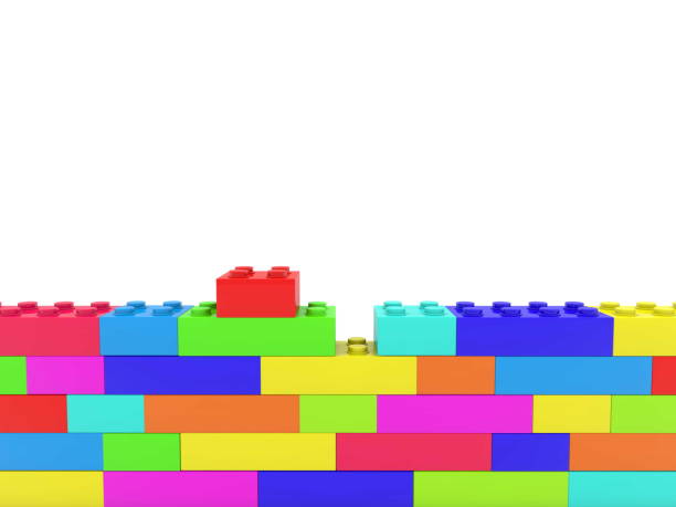 istock Unfinished wall of colorful toy bricks on white 979060500