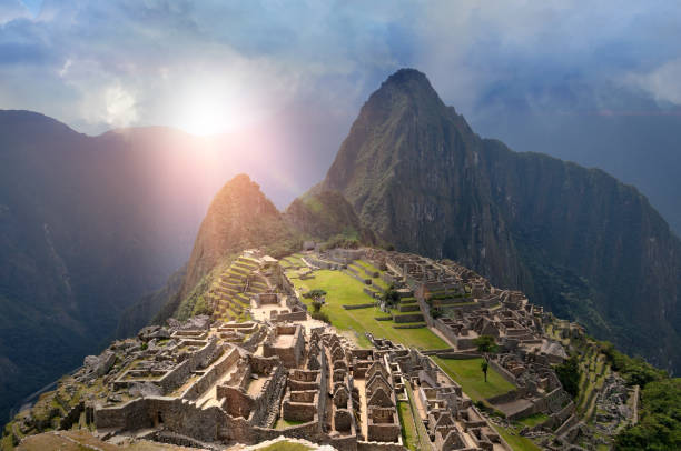 Machu Picchu Under Sun Lights Machu Picchu with fictional weather situation perspective empire stock pictures, royalty-free photos & images