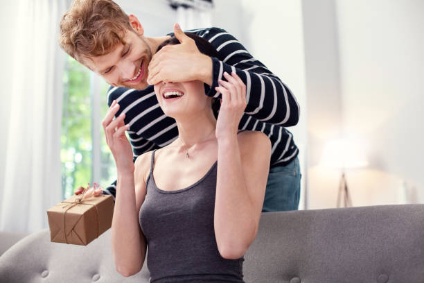 istock Joyful nice man preparing a gift for his girlfriend 979065934