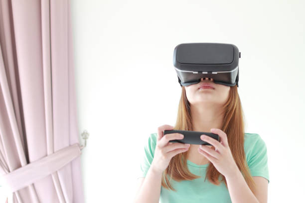 istock Young woman wearing virtual reality glasses at home. 979071950