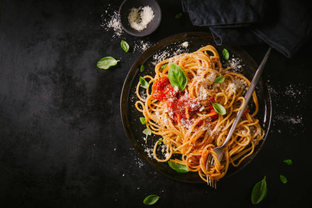 istock Dark plate with italian spaghetti on dark 979075094