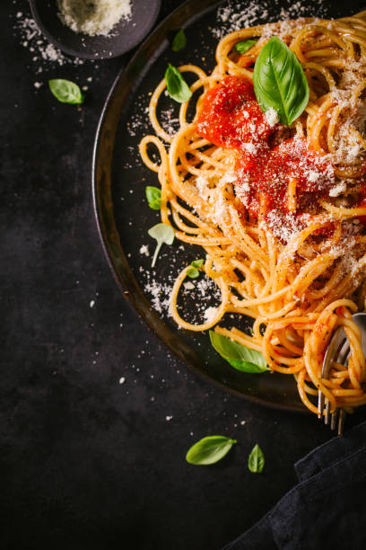 istock Dark plate with italian spaghetti on dark 979075132