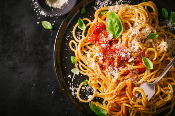 istock Dark plate with italian spaghetti on dark 979075256