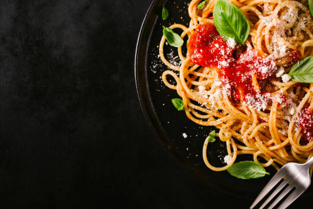 istock Dark plate with italian spaghetti on dark 979075384