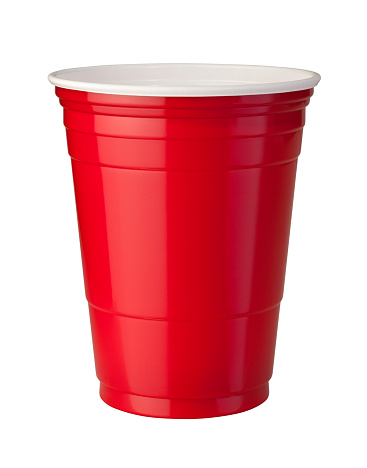 Red plastic party cup shown with shiny reflective highlight. This container is popular at parties because it is strong and disposable. The image is isolated on a white background, and includes a clipping path.