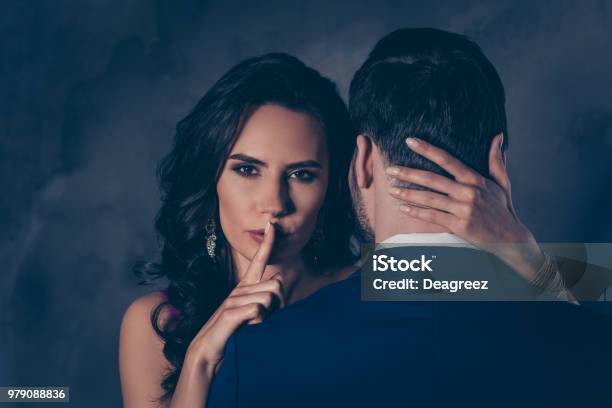 Shh Portrait Of Tempting Brunette Lady Showing Silence Sign With Forefinger Touching Secret Mysterious Gentlemen With Rear View Lovely Mr And Mrs Isolated On Grey Background Stock Photo - Download Image Now