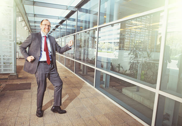 istock Businessman dances joyfully outside his office 979092704