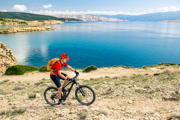 istock Mountain biker riding on bike in summer sunset woods 979093070