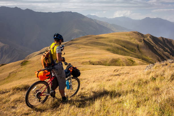 mountain biker is checking gps location after atsunta pass in the highlands of tusheti region, georgia - tusheti imagens e fotografias de stock