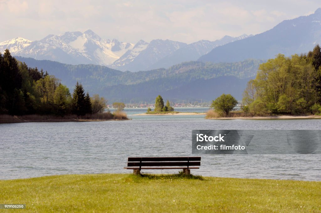 tranquil scene at lake Forggensee and mountain range Forggensee Lake Stock Photo