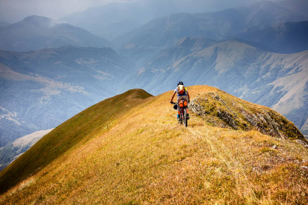 mountain biker is travelling in the highlands of tusheti region, georgia - tusheti imagens e fotografias de stock