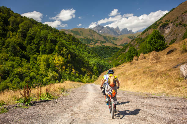 mountain bikers are travelling in the highlands of tusheti region, georgia - tusheti imagens e fotografias de stock