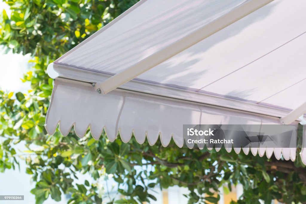 new white awning of coffee shop in garden background Awning Stock Photo