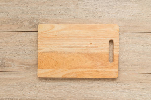 istock Close-Up Of Cutting Board On Wooden Table 979115672