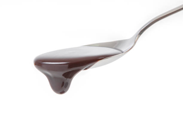istock chocolate syrup pouring on spoon, cooking, baking 979120644