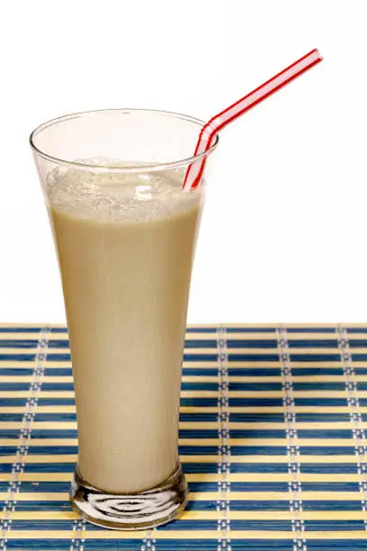 Horchata is a drink, made with the juice of tiger nuts and sugar. Native from Valencia Spain, it is a refreshing drink. Isolated background on white.