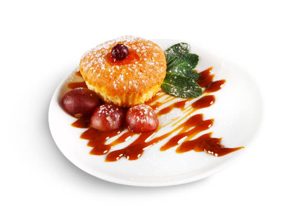 istock Tasty muffin served with sauce, isolated on white 979125652