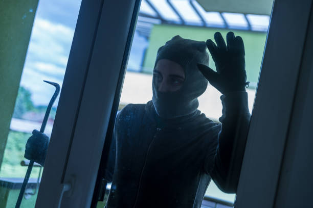 istock Burglar Breaking Into House 979130502