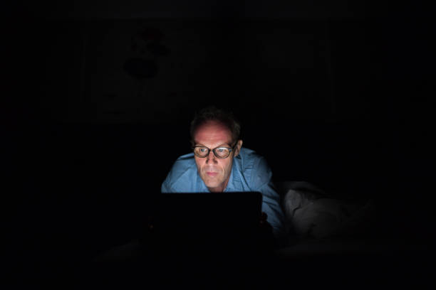 istock Mature Scandinavian man using digital tablet in dark room 979132536