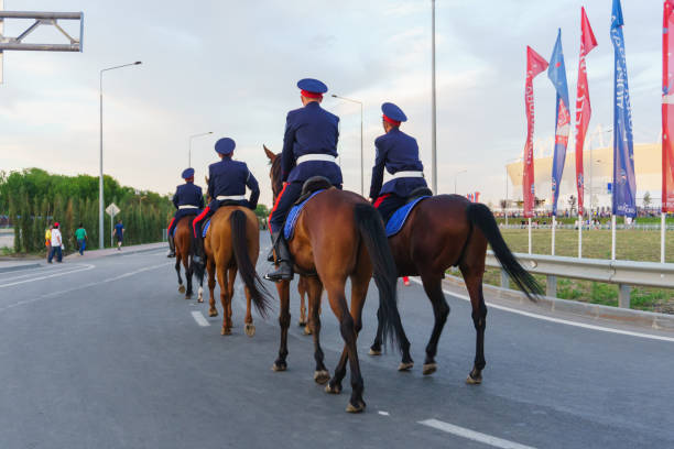 Don Cossacks in blue uniform riding on a brown horse are on duty during football matches Rostov-on-Don / Russia - 17 June 2018: Don Cossacks in blue uniform riding on a brown horse are on duty during football matches diyarbakirda escort stock pictures, royalty-free photos & images