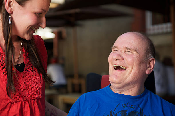 istock Man with a disability laughing to woman at cafe 97914777