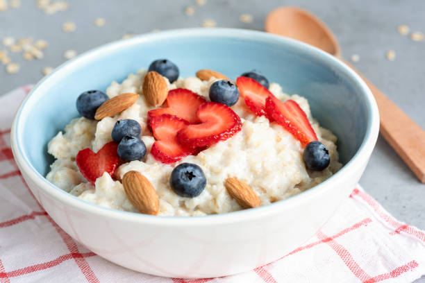 istock Hot oatmeal porridge with fresh berries and nuts 979150020