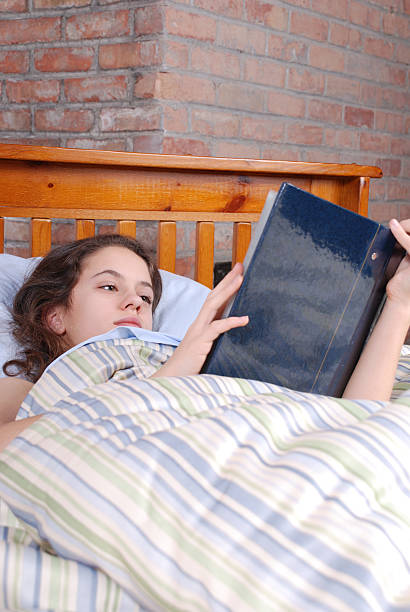 istock Girl reading in bed 97915250