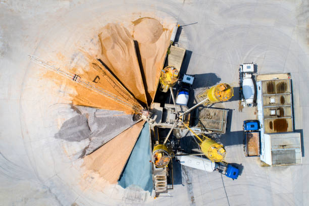 Gravel and sand open pit mining Gravel and sand open pit mining - aerial view, sandhills and silo trucks mining conveyor belt stock pictures, royalty-free photos & images