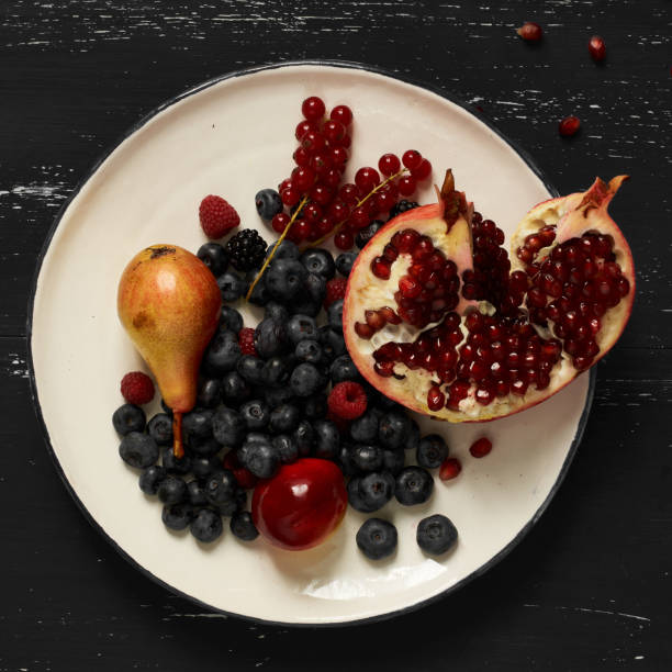 Fruits and berries lying on round plate