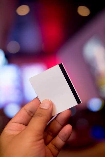 istock Hand holding white blank ticket paper, close up 979182988