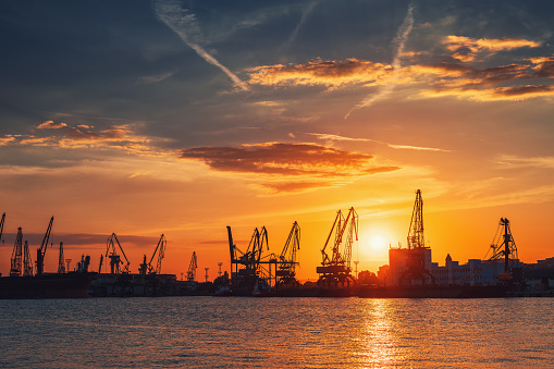 Colorful sunset over sea port and industrial cranes, Varna, Bulgaria