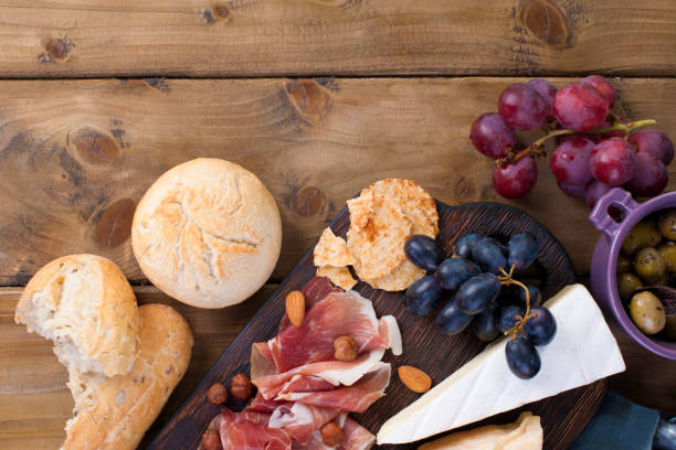 istock Snack to wine. Fresh baked bread. Different snack for wine. Cheese, olives, grapes copy space. flat lay 979190190