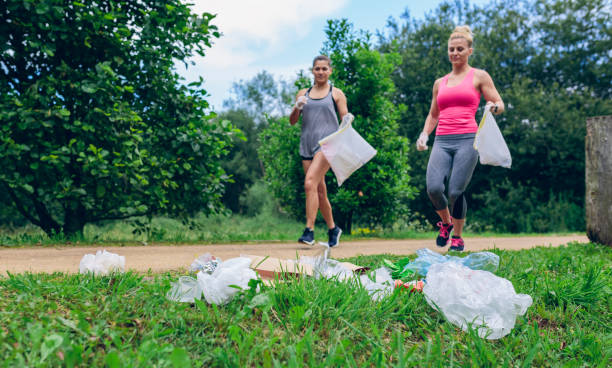 istock Waste pile and two girls doing plogging 979194434