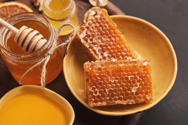 istock Honey jars and honeycombs, closeup 979194484