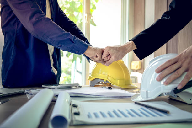 istock Engineer and architect shake hands agree deal of success that finish design and construction project 979195228