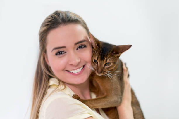 istock Happy woman holding a beautiful cat 979195992