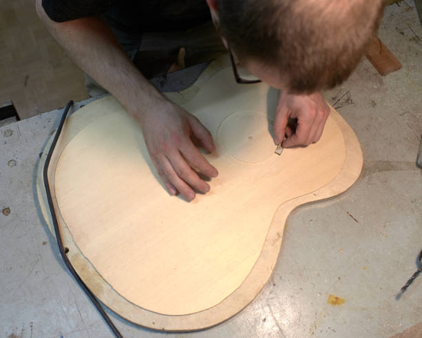 istock The guitar master pastes the rosette into a classical guitar. 979198626