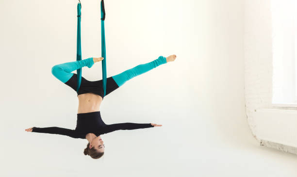 istock Woman practicing fly yoga over white background 979198844